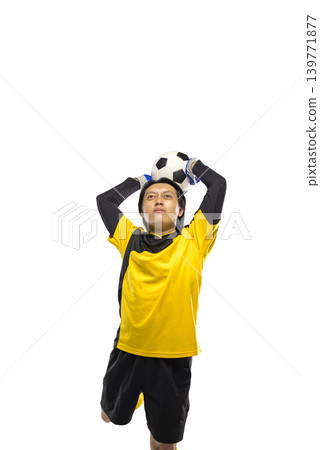 Professional Indonesian southeast asian soccer goalkeeper in yellow jersey jumping high to catch a football, action shot isolated on white background Professional Indonesian southeast asian soccer goalkeeper in yellow jersey jumping high to catch a football, action shot isolated on white background 139771877