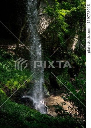 Image of foreign tourists experiencing waterfall meditation. Image of foreign tourists experiencing waterfall meditation. 139772028