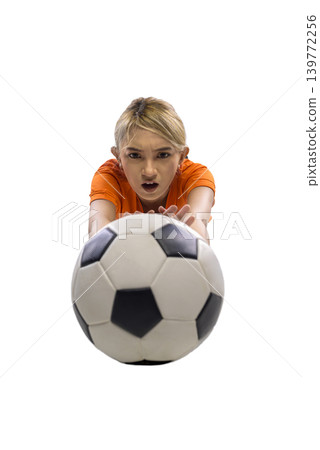 A determined young Indonesian southeast asian woman in an orange jersey reaches out to catch or block a soccer ball, showcasing athletic intensity and focus, isolated on a white background A determined young Indonesian southeast asian woman in an orange jersey reaches out to catch or block a soccer ball, showcasing athletic intensity and focus, isolated on a white background 139772256