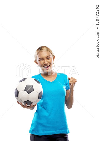 A happy young Indonesian southeast asian woman in a blue t-shirt holding a soccer ball and celebrating with a clenched fist, isolated on a white background. Concept of sports enthusiasm and victory A happy young Indonesian southeast asian woman in a blue t-shirt holding a soccer ball and celebrating with a clenched fist, isolated on a white background. Concept of sports enthusiasm and victory 139772262