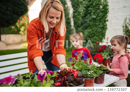 Gardening joy with kids in a sunny backyard Gardening joy with kids in a sunny backyard 139772307