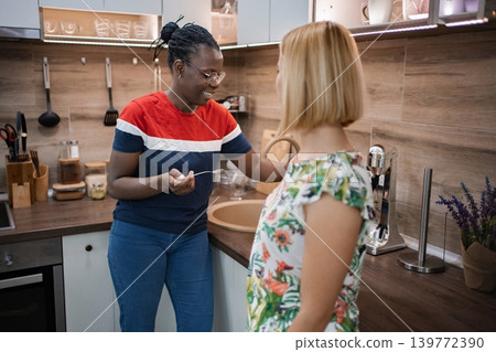 Joyful cooking together in a modern kitchen during afternoon light 139772390