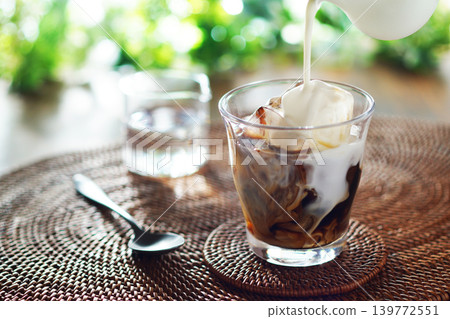 Summer iced café au lait - pour milk into iced coffee 139772551