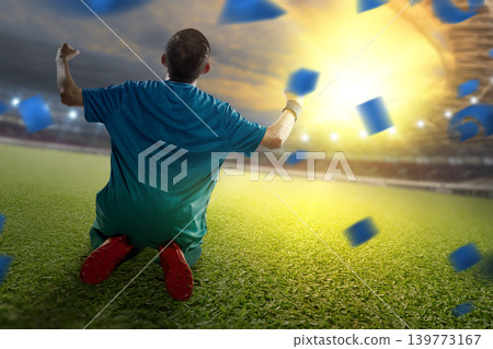 A professional Indonesian southeast asian soccer player in a blue jersey celebrates a goal on his knees on the field, surrounded by falling confetti and bright stadium lights A professional Indonesian southeast asian soccer player in a blue jersey celebrates a goal on his knees on the field, surrounded by falling confetti and bright stadium lights 139773167
