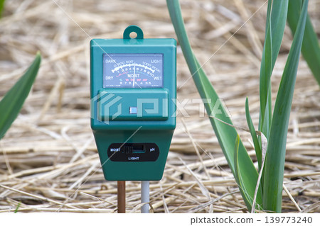 Soil Moisture Meter In Garden Mulch Next To Green Plants Measuring Moisture And Light 139773240
