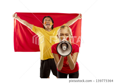 Excited Indonesian southeast asian man and woman cheering for their team, holding a large red flag and a megaphone with face paint, isolated on a white background Excited Indonesian southeast asian man and woman cheering for their team, holding a large red flag and a megaphone with face paint, isolated on a white background 139773364
