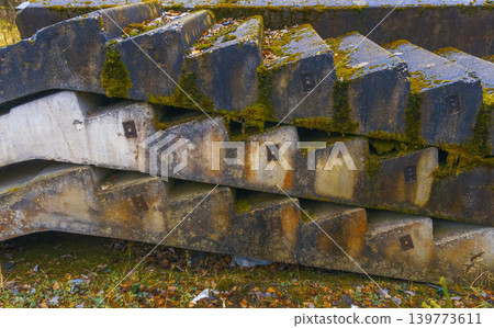 Reclaimed concrete beams with distressed edges and geometric patterns emphasize practical industrial design Reclaimed concrete beams with distressed edges and geometric patterns emphasize practical industrial design 139773611