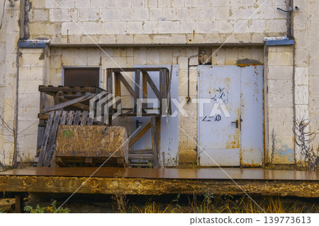 Abandoned factory equipment remaining. Unused industrial area shows signs of weathering and deterioration Abandoned factory equipment remaining. Unused industrial area shows signs of weathering and deterioration 139773613