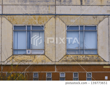 Suburban window with curtains. Close shot of residential window with aged details and soft lighting Suburban window with curtains. Close shot of residential window with aged details and soft lighting 139773651