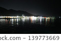 The beautiful illumination of buildings and the reflection of the lights on the water create a stunning night view of the harbor. 139773669