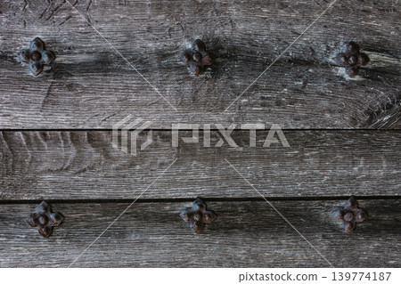 Rustic wood texture or background. Old wooden door with iron rivets. Rustic wood texture or background. Old wooden door with iron rivets. 139774187