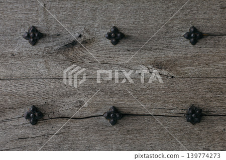 Rustic wood texture or background. Old wooden door with iron rivets. Rustic wood texture or background. Old wooden door with iron rivets. 139774273