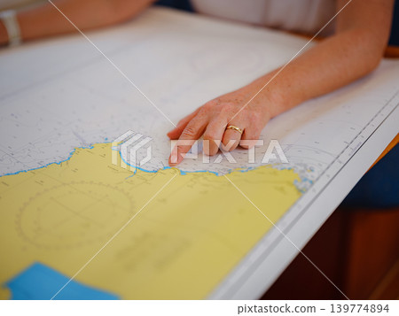 Woman Sailor Studying Navigation Map Inside Yacht Cabin Interior Woman Sailor Studying Navigation Map Inside Yacht Cabin Interior 139774894