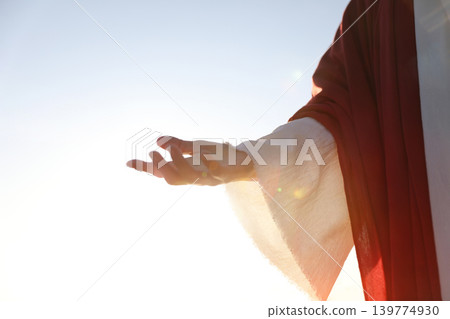 A background of the holy hand of Jesus Christ extending the hand of salvation and guiding souls with the light of love and hope. A background of the holy hand of Jesus Christ extending the hand of salvation and guiding souls with the light of love and hope. 139774930