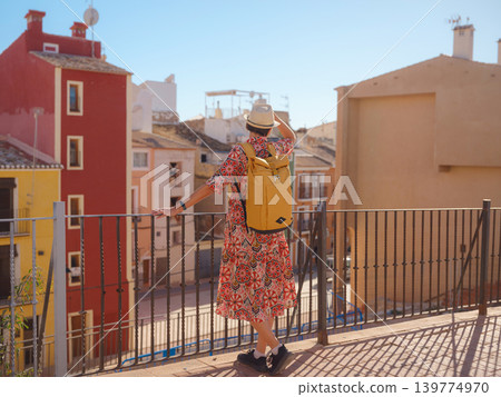 Woman strolls through colorful streets of Spanish coastal town Woman strolls through colorful streets of Spanish coastal town 139774970