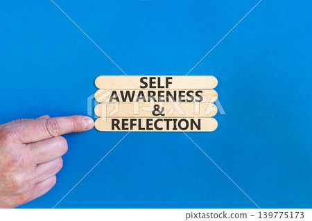 Self awareness and reflection symbol. Concept words Self awareness and reflection on beautiful wooden sticks. Beautiful blue background. Psychological self awareness reflection concept. Copy space. Self awareness and reflection symbol. Concept words Self awareness and reflection on beautiful wooden sticks. Beautiful blue background. Psychological self awareness reflection concept. Copy space. 139775173