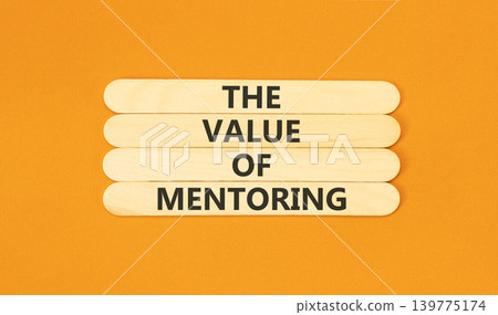 The value of mentoring words symbol. Concept words The value of mentoring on beautiful wooden sticks. Beautiful orange background. Business the value of mentoring concept. Copy space. The value of mentoring words symbol. Concept words The value of mentoring on beautiful wooden sticks. Beautiful orange background. Business the value of mentoring concept. Copy space. 139775174