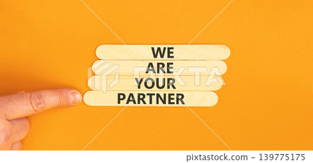 We are your partner symbol. Concept words We are your partner on beautiful wooden sticks. Beautiful orange background. Businessman hand. Business motivational we are your partner concept. Copy space. We are your partner symbol. Concept words We are your partner on beautiful wooden sticks. Beautiful orange background. Businessman hand. Business motivational we are your partner concept. Copy space. 139775175