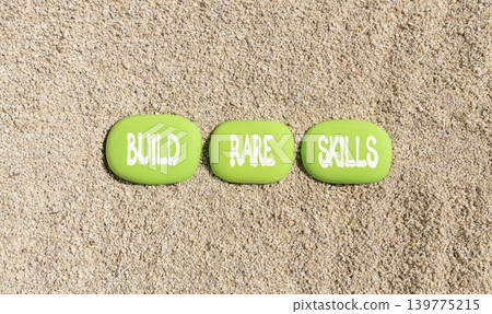 Build rare skills words symbol. Concept words Build rare skills on beautiful green stones. Beautiful sand beach background. Business and build rare skills concept. Copy space. Build rare skills words symbol. Concept words Build rare skills on beautiful green stones. Beautiful sand beach background. Business and build rare skills concept. Copy space. 139775215