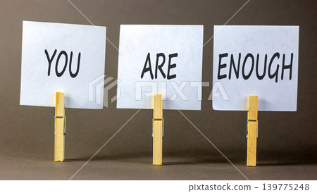 You are enough words symbol. Concept words You are enough on beautiful white papers on wooden clothespin. Beautiful grey background. Business motivational and you are enough concept. Copy space. You are enough words symbol. Concept words You are enough on beautiful white papers on wooden clothespin. Beautiful grey background. Business motivational and you are enough concept. Copy space. 139775248