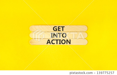 Get into action words symbol. Concept words Get into action on beautiful wooden sticks. Beautiful yellow background. Business and Get into action concept. Copy space. 139775257
