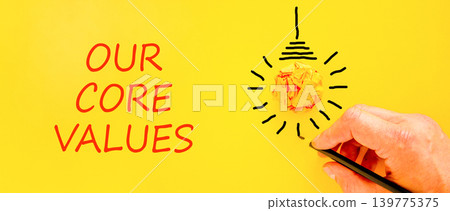 Our core values words symbol. Concept words Our core values on beautiful yellow paper. Beautiful yellow background. Businessman hand. Business our core values motivational support concept. Copy space. Our core values words symbol. Concept words Our core values on beautiful yellow paper. Beautiful yellow background. Businessman hand. Business our core values motivational support concept. Copy space. 139775375