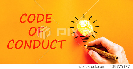 Code of conduct words symbol. Concept words Code of conduct on beautiful orange paper. Beautiful orange background. Light bulb icon. Businessman hand. Business Code of conduct concept. Copy space. Code of conduct words symbol. Concept words Code of conduct on beautiful orange paper. Beautiful orange background. Light bulb icon. Businessman hand. Business Code of conduct concept. Copy space. 139775377