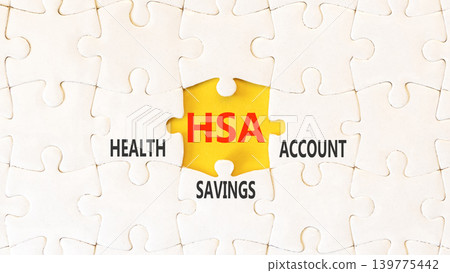 HSA health saving account symbol. Concept words HSA health saving account on beautiful white puzzles. Beautiful yellow background. Medical HSA health saving account concept. Copy space. HSA health saving account symbol. Concept words HSA health saving account on beautiful white puzzles. Beautiful yellow background. Medical HSA health saving account concept. Copy space. 139775442