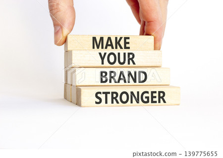 Make your brand stronger symbol. Concept words Make your brand stronger on beautiful wooden blocks. Beautiful white background. Businessman hand. Business make your brand stronger concept. Copy space Make your brand stronger symbol. Concept words Make your brand stronger on beautiful wooden blocks. Beautiful white background. Businessman hand. Business make your brand stronger concept. Copy space 139775655