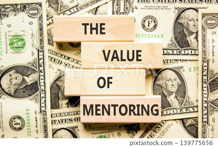 The value of mentoring words symbol. Concept words The value of mentoring on beautiful wooden blocks. Beautiful dollar bills background. Business the value of mentoring concept. Copy space. The value of mentoring words symbol. Concept words The value of mentoring on beautiful wooden blocks. Beautiful dollar bills background. Business the value of mentoring concept. Copy space. 139775656
