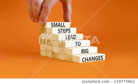 Small steps big changes words symbol. Concept words Small steps lead to big changes on beautiful wooden sticks. Beautiful orange background. Business small steps big changes concept. Copy space. Small steps big changes words symbol. Concept words Small steps lead to big changes on beautiful wooden sticks. Beautiful orange background. Business small steps big changes concept. Copy space. 139775662