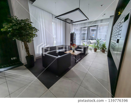 Modern office lobby waiting room with leather furniture and mailboxes Modern office lobby waiting room with leather furniture and mailboxes 139776396
