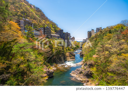 Nikko City, Tochigi Prefecture: A beautiful valley surrounded by fresh greenery and a cluster of abandoned hotels in Kinugawa Onsen. Nikko City, Tochigi Prefecture: A beautiful valley surrounded by fresh greenery and a cluster of abandoned hotels in Kinugawa Onsen. 139776447