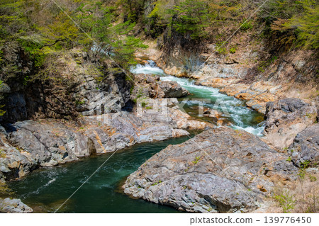 Nikko City, Tochigi Prefecture: The rapid currents of the Kinugawa River flowing through the rocky cliffs and the beauty of the lush green valley. 139776450