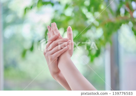 Body parts of a young woman taking care of her hands 139776583