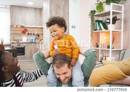 Happy multiracial family enjoying playful time at home together Happy multiracial family enjoying playful time at home together 139777608