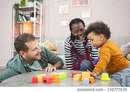 Multiracial family playing with colorful blocks at home Multiracial family playing with colorful blocks at home 139777630
