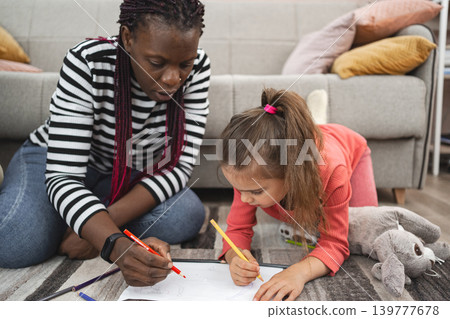 A multiracial family enjoys an art activity together at home A multiracial family enjoys an art activity together at home 139777678