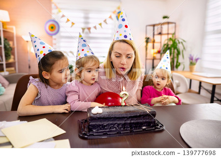 Children joyfully celebrate with cake and balloons at a birthday party Children joyfully celebrate with cake and balloons at a birthday party 139777698