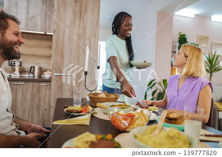 A delightful gathering with friends sharing a homemade meal A delightful gathering with friends sharing a homemade meal 139777820