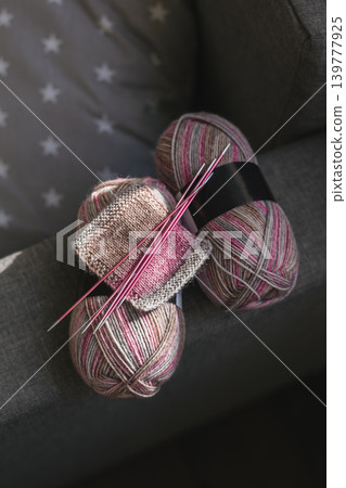 Skeins of woolen yarn and needles for hand knitting socks. Natural colors. 139777925