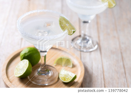 Classic margarita cocktail with lime and salt rim Classic margarita cocktail with lime and salt rim 139778042