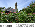 A giant statue beyond the flowerbed 139778195