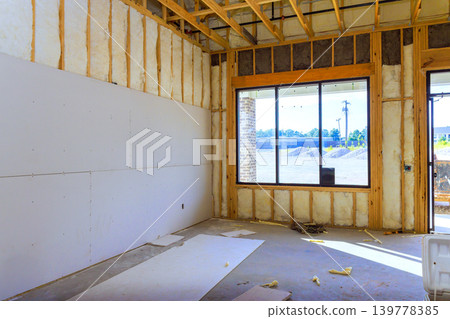 Workers are preparing space for future construction with drywall open framing inside. 139778385