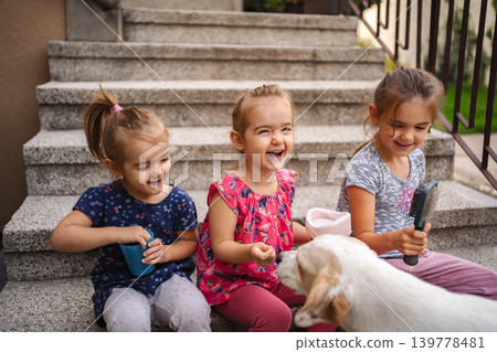 Joyful moments of friendship and play with a playful puppy outside Joyful moments of friendship and play with a playful puppy outside 139778481