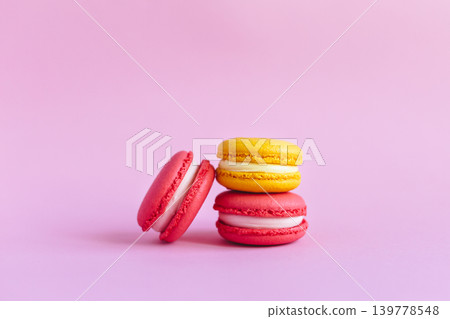 Three tasty french macarons on pink background. Three tasty french macarons on pink background. 139778548