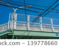 Overhead wires stretched over a pedestrian overpass 139778660