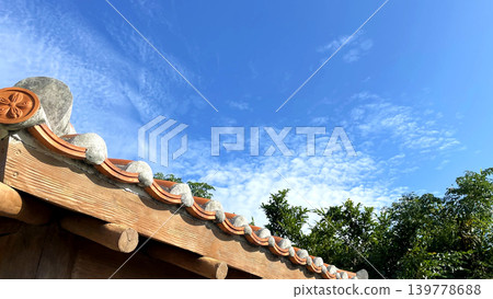 Red tiled roofs stand out against the blue sky: A quintessential Okinawan landscape. (Copy space) Red tiled roofs stand out against the blue sky: A quintessential Okinawan landscape. (Copy space) 139778688