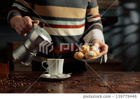 Profiteroles with mascarpone and cup of black coffee. Profiteroles with mascarpone and cup of black coffee. 139779446