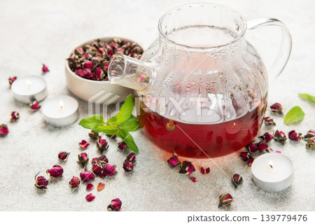 Rose tea brewing in glass teapot with dried buds Rose tea brewing in glass teapot with dried buds 139779476